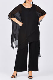 Model Jess wearing size 14 of the Sandra Jumpsuit in colour Black (Black), from the front, cropped image