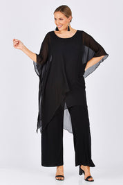 Model Jess wearing size 14 of the Sandra Jumpsuit in colour Black (Black), from the front, showing the whole outfit