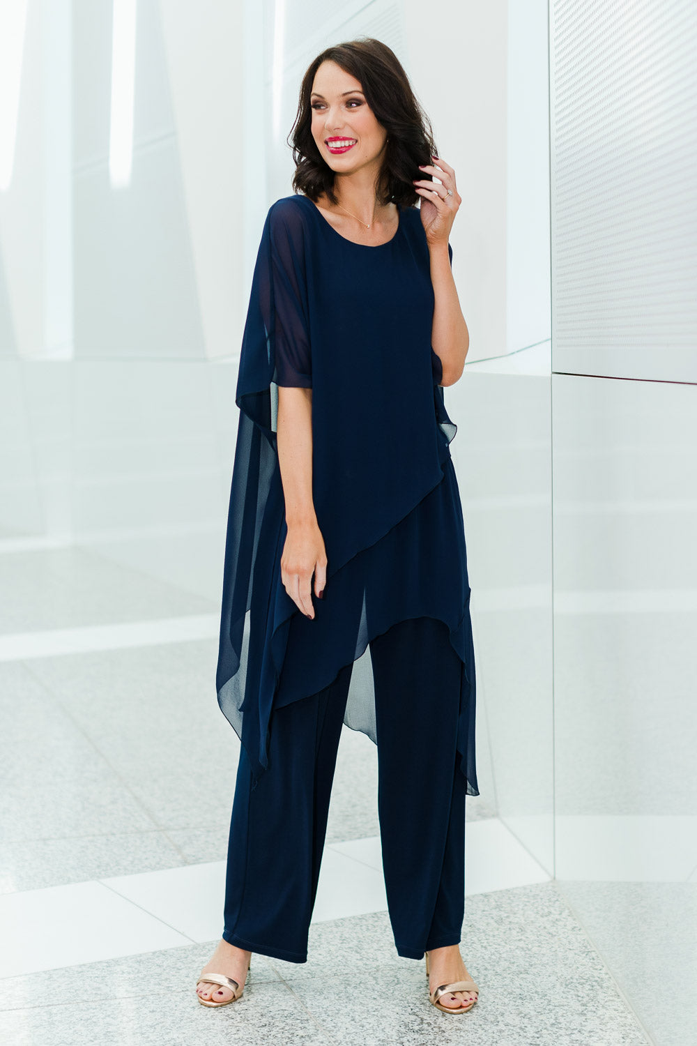 Model Andrea wearing size 10 of the Sandra Jumpsuit in colour Navy (Blue), from the front, showing the whole outfit