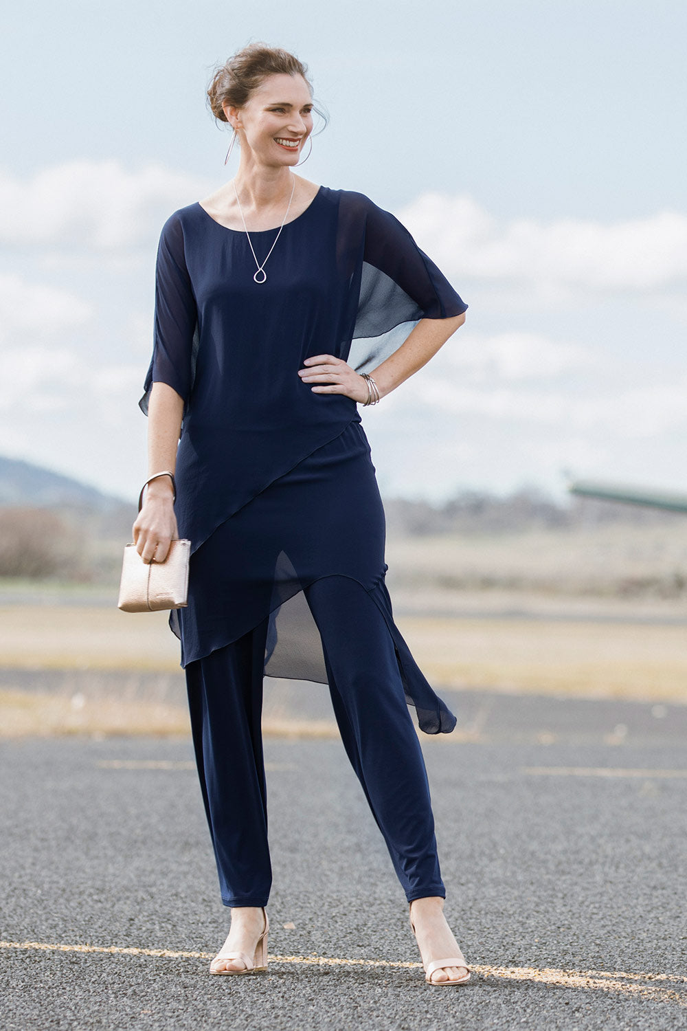 Model Anneliese wearing size 10 of the Sandra Jumpsuit in colour Navy (Blue), from the front, showing the whole outfit
