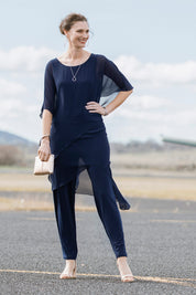Model Anneliese wearing size 10 of the Sandra Jumpsuit in colour Navy (Blue), from the front, showing the whole outfit
