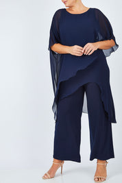 Model Fiona wearing size 16 of the Sandra Jumpsuit in colour Navy (Blue), from the front, cropped image