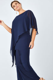 Model Fiona wearing size 16 of the Sandra Jumpsuit in colour Navy (Blue), from the front, cropped image