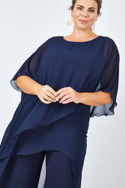Model Fiona wearing size 16 of the Sandra Jumpsuit in colour Navy (Blue), from the front, cropped image