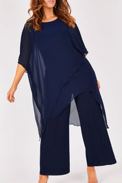 Model Laura wearing size 12 of the Sandra Jumpsuit in colour Navy (Blue), from the front, cropped image