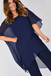 Model Laura wearing size 12 of the Sandra Jumpsuit in colour Navy (Blue), from the front, cropped image