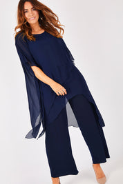 Model Laura wearing size 12 of the Sandra Jumpsuit in colour Navy (Blue), from the front, showing the whole outfit