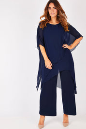 Model Laura wearing size 14 of the Sandra Jumpsuit in colour Navy (Blue), from the front, showing the whole outfit