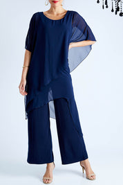 Model Madeline wearing size 10 of the Sandra Jumpsuit in colour Navy (Blue), from the front, cropped image