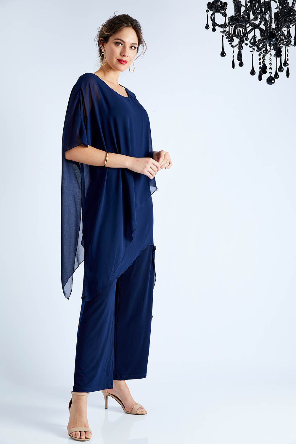 Model Madeline wearing size 10 of the Sandra Jumpsuit in colour Navy (Blue), from the front, showing the whole outfit