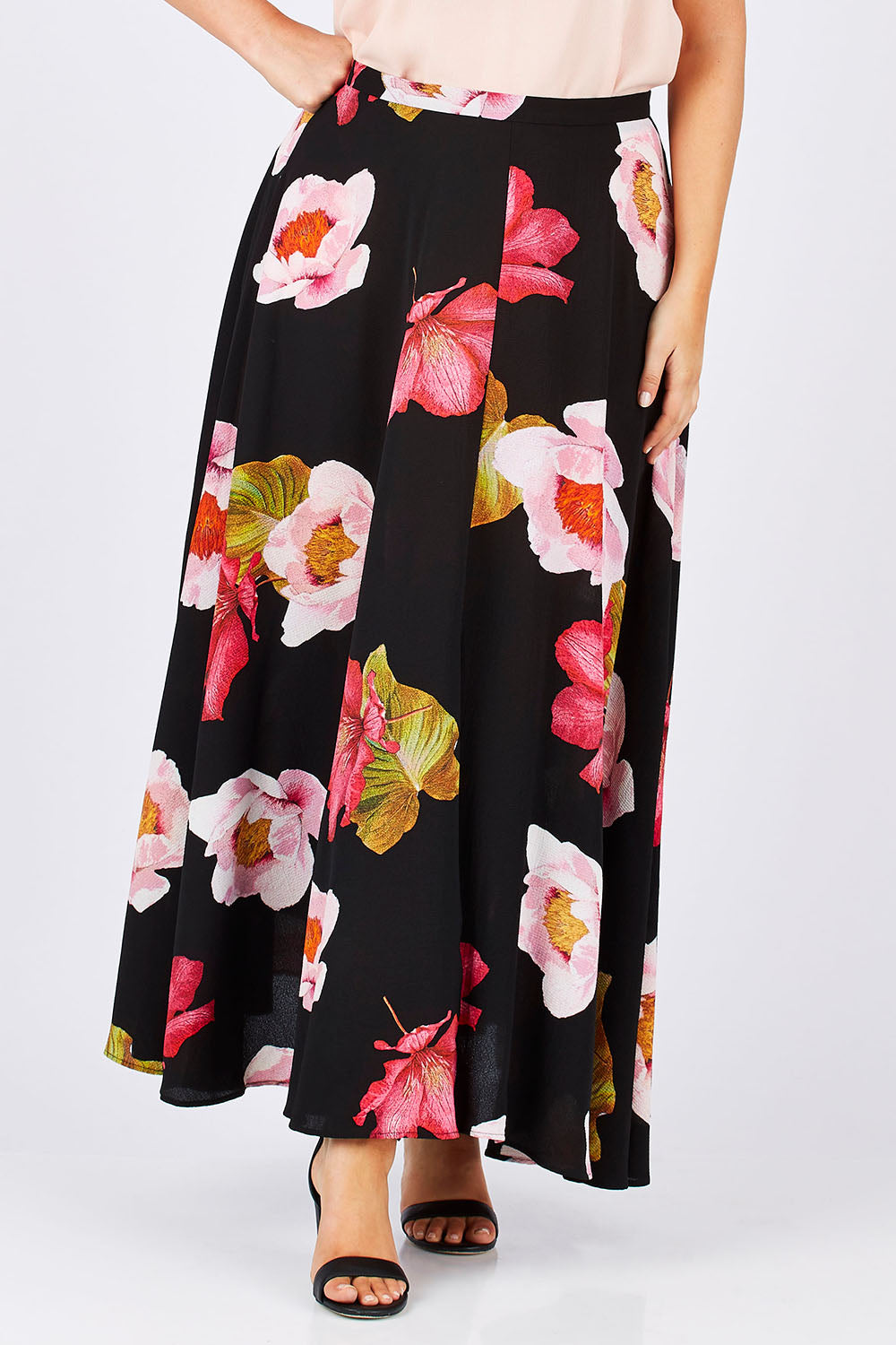 Model Jess wearing size 14 of the Hannah Skirt in colour Goddess (Black), from the front, cropped image