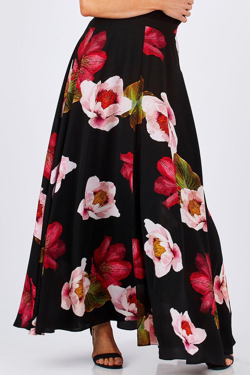 Model Monique wearing size 8 of the Hannah Skirt in colour Goddess (Black), from the front, cropped image