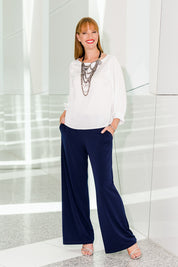 Model Katie wearing size 10 of the Kristi Pants in colour Navy (Blue), from the front, showing the whole outfit