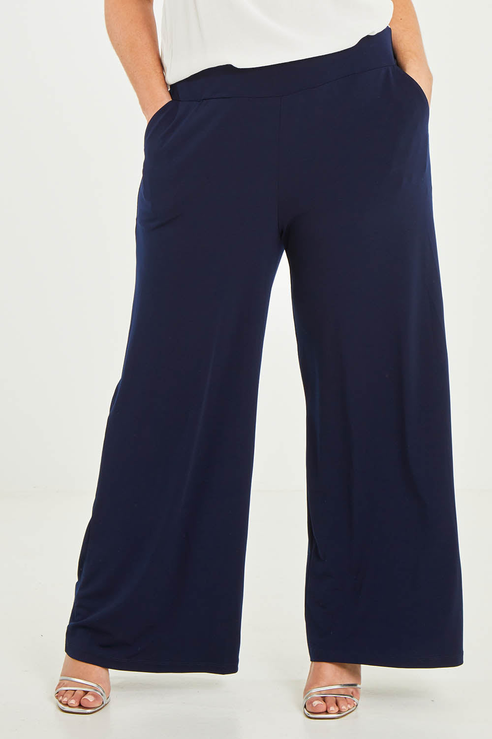 Model Katie wearing size 16 of the Kristi Pants in colour Navy (Blue), from the front, cropped image