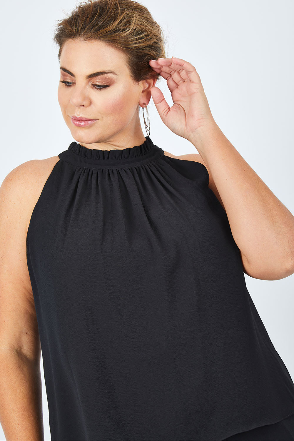 Model Fiona wearing size 16 of the Liz Top in colour Black (Black), from the front, cropped image