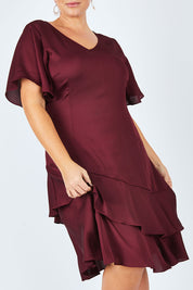 Model Fiona wearing size 16 of the Kimberley Dress in colour Wine (Red), from the front, cropped image