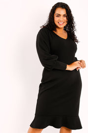 Model Sasha-Lee wearing size 16 of the Sophie Dress in colour Black (Black), from the front, cropped image