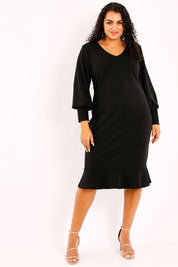 Model Sasha-Lee wearing size 16 of the Sophie Dress in colour Black (Black), from the front, showing the whole outfit