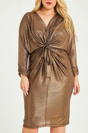 Model Katie wearing size 16 of the Nancy Dress in colour Bronze (Metallics), from the front, cropped image