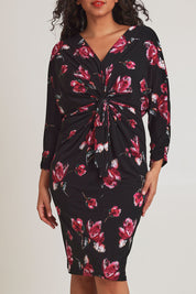 Model Terri-Leigh wearing size 14 of The Printed Nancy Dress in colour Roses (Black), from the front, cropped image