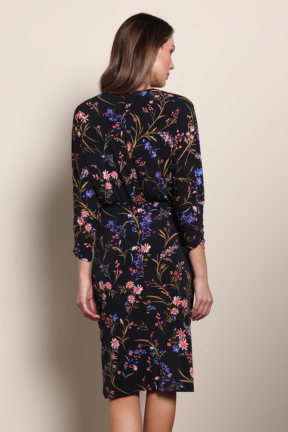 Model Maddiec wearing size 10 of the The Printed Nancy Dress – Floral in colour Floral, from the back