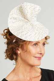 Model Emma wearing size OneSize of the Zaria Fascinator in colour Ivorygold (White), from the front, showing the whole outfit