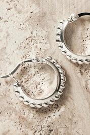 A model wearing the Chia Silver Hoop Earrings in colour Silver (Metallics), from the front, showing the whole outfit