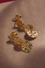A model wearing the Milleluci Yellow Gold Circular Petite Drop Earring in colour Gold (Metallics), from the front, showing the whole outfit