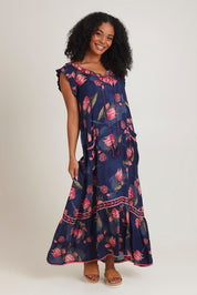 Model Ziara wearing size S of the Epson Maxi Dress in colour Frolic (Blue), from the front, showing the whole outfit