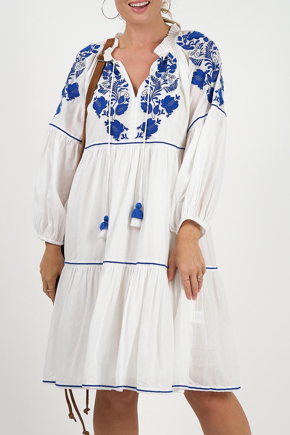 A model wearing the Molly Cotton Dress in colour Elsa (White), from the front, cropped image