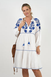 A model wearing the Molly Cotton Dress in colour Elsa (White), from the front, cropped image