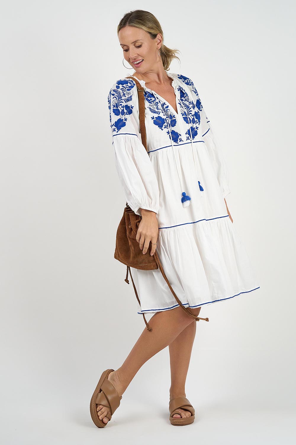 A model wearing the Molly Cotton Dress in colour Elsa (White), from the front, showing the whole outfit