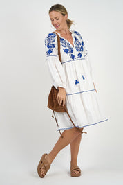 A model wearing the Molly Cotton Dress in colour Elsa (White), from the front, showing the whole outfit