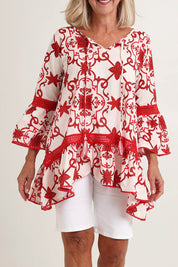Model Fiona wearing size S of the Hacienda Cotton Tunic in colour Jemmared (Red), from the front, cropped image