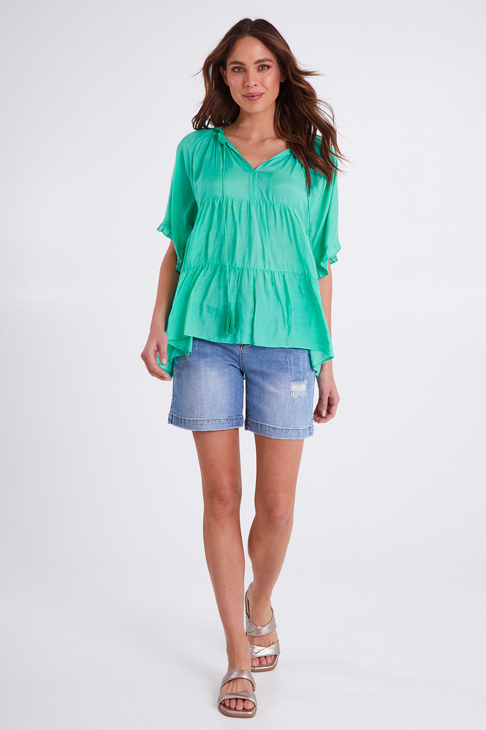 Model Madeline wearing size S of the Matilda Top in colour Emerald (Green), from the front, showing the whole outfit