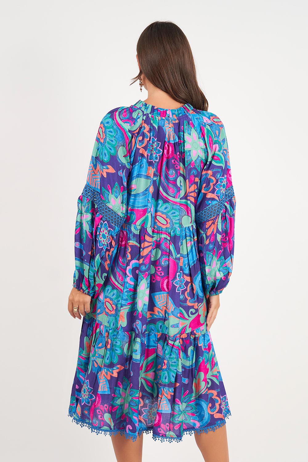 A model wearing the Molly Dress in colour Enigma (Blue), from the back