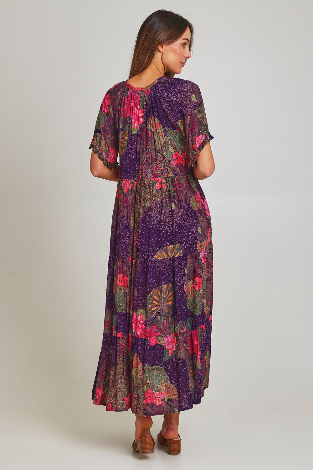 Model Madeline wearing size S of the Amisha Short Sleeve Maxi Dress in colour Waterlily (Blue), from the back