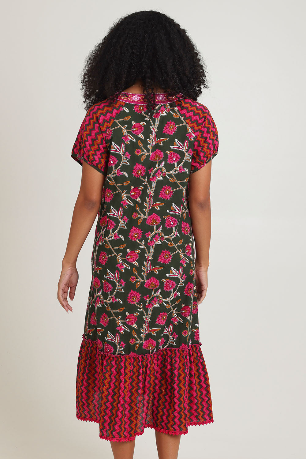 Model Ziara wearing size S of the Sao Paulo Cotton Midi Dress in colour Jewel (Green), from the back