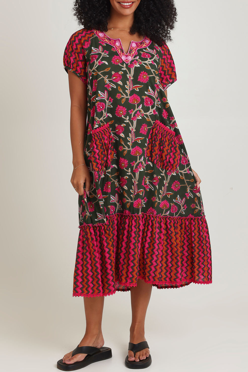 Model Ziara wearing size S of the Sao Paulo Cotton Midi Dress in colour Jewel (Green), from the front, cropped image