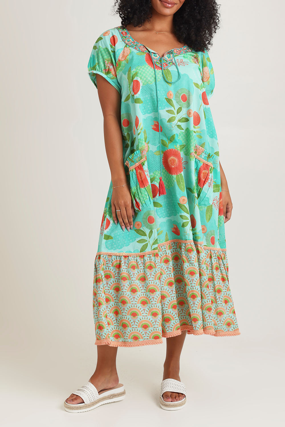Model Ziara wearing size S of the Sao Paulo Cotton Midi Dress in colour Sunny (Green), from the front, cropped image