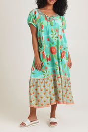 Model Ziara wearing size S of the Sao Paulo Cotton Midi Dress in colour Sunny (Green), from the front, cropped image