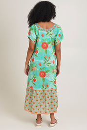 Model Ziara wearing size S of the Sao Paulo Cotton Midi Dress in colour Sunny (Green), from the front, cropped image