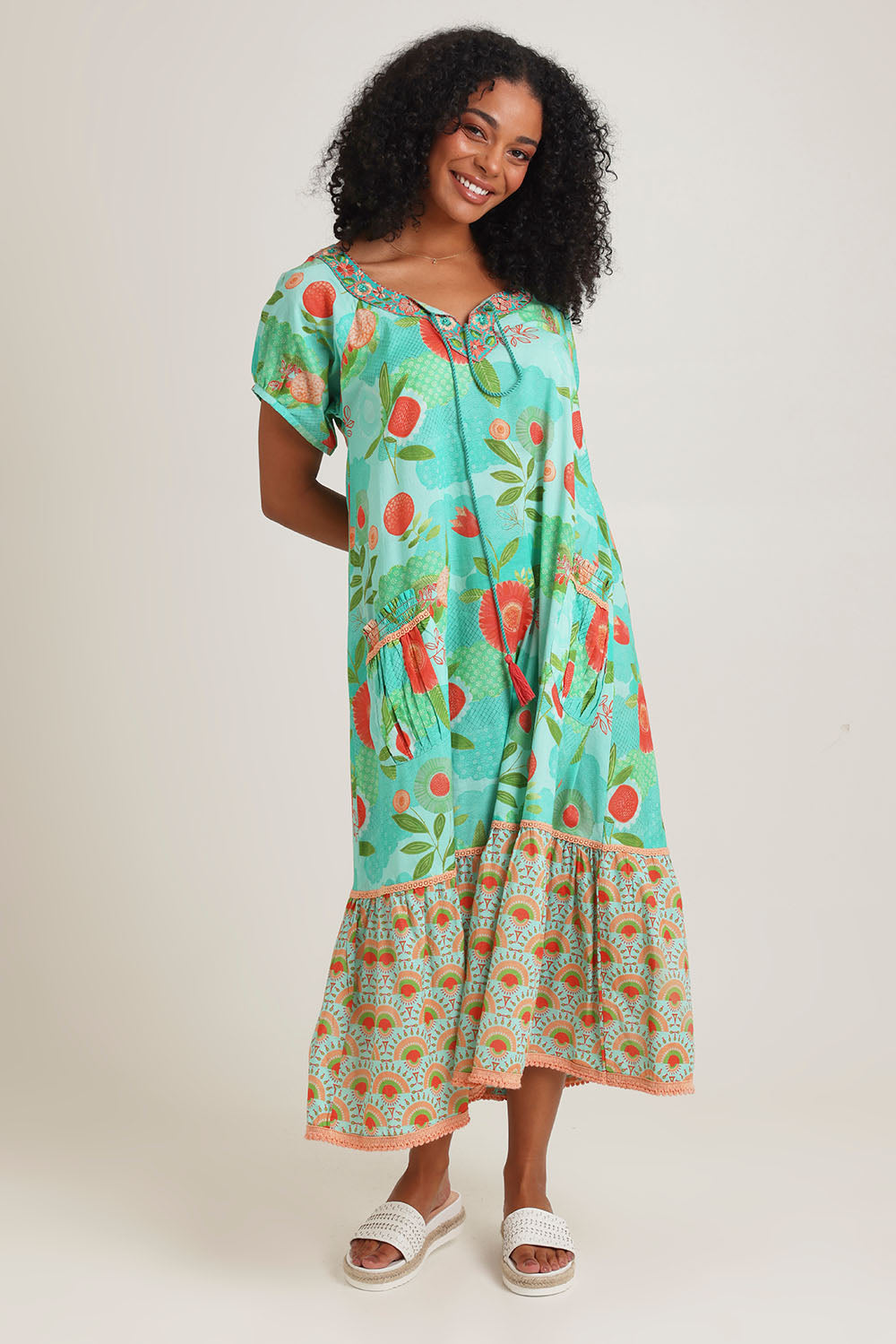 Model Ziara wearing size S of the Sao Paulo Cotton Midi Dress in colour Sunny (Green), from the front, showing the whole outfit