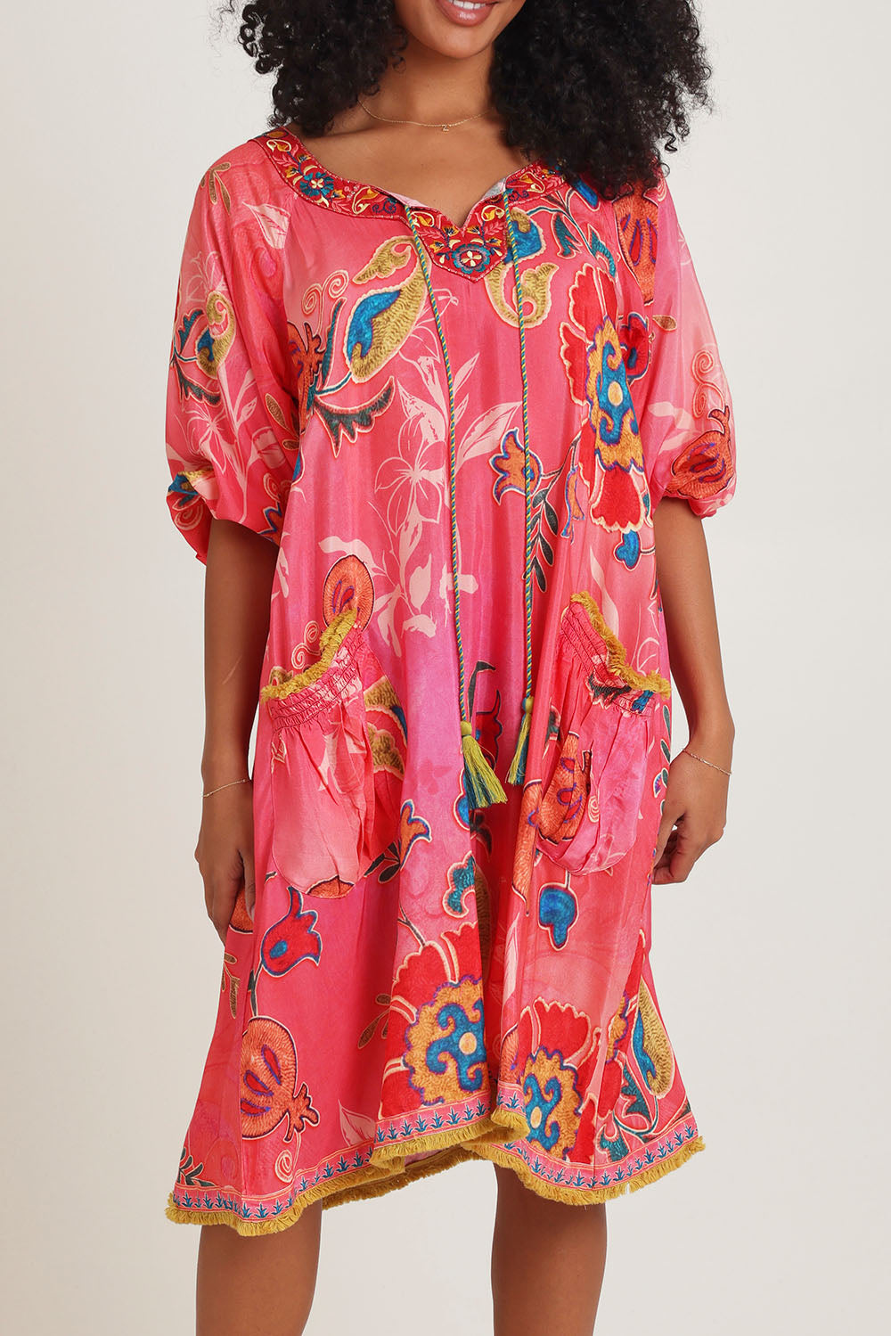 Model Ziara wearing size S of the Sao Paulo Long Sleeve Dress in colour Gloria (Pink), from the front, cropped image