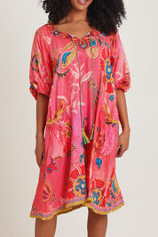 Model Ziara wearing size S of the Sao Paulo Long Sleeve Dress in colour Gloria (Pink), from the front, cropped image