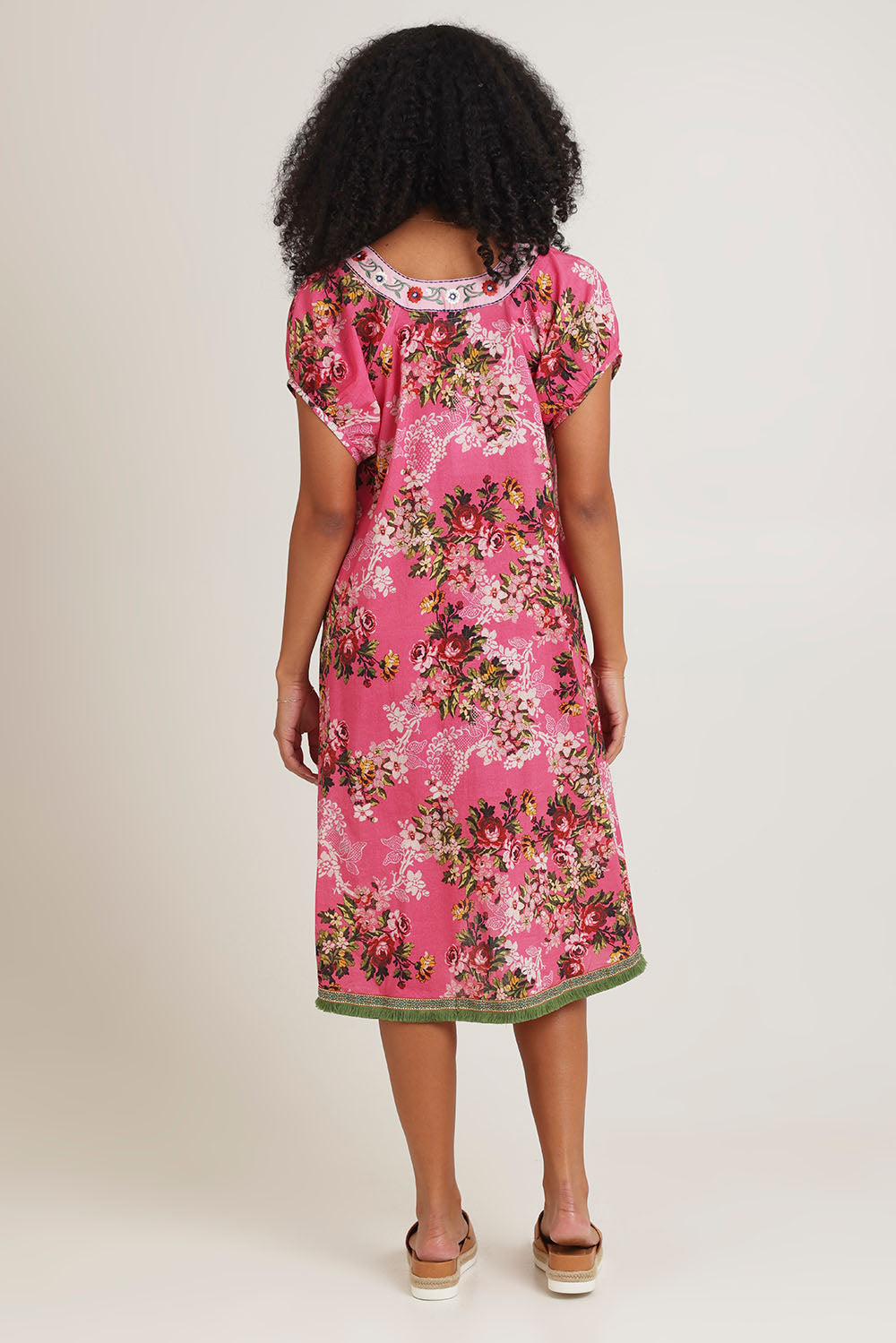 Model Ziara wearing size S of the Sao Paulo Cotton Dress in colour Folly (Pink), from the back