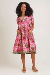 Model Ziara wearing size S of the Sao Paulo Cotton Dress in colour Folly (Pink), from the front, showing the whole outfit