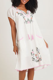 Model Ziara wearing size S of the Sao Paulo Cotton Dress in colour Jewel (White), from the front, cropped image
