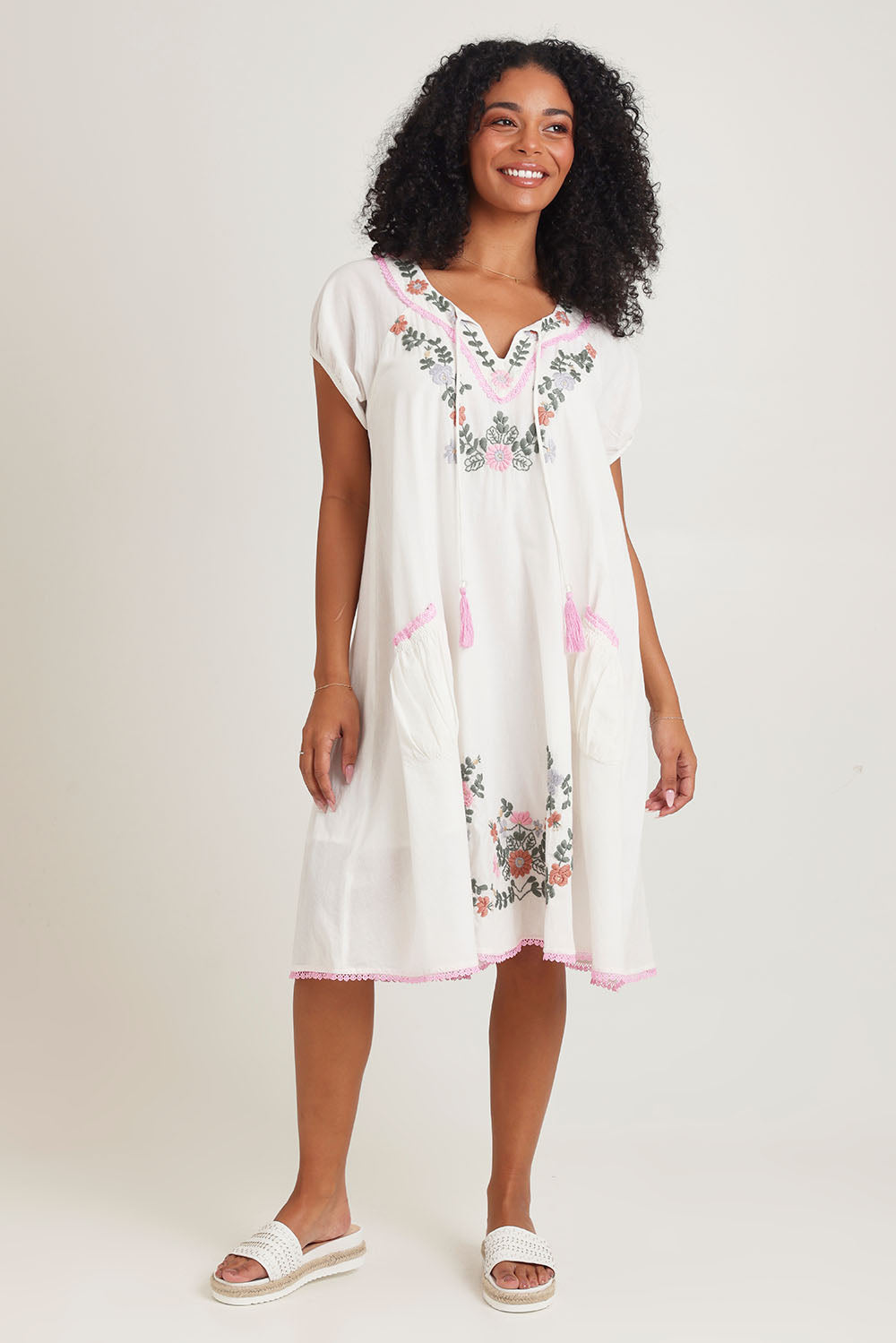 Model Ziara wearing size S of the Sao Paulo Cotton Dress in colour Jewel (White), from the front, showing the whole outfit