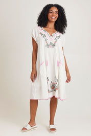 Model Ziara wearing size S of the Sao Paulo Cotton Dress in colour Jewel (White), from the front, showing the whole outfit